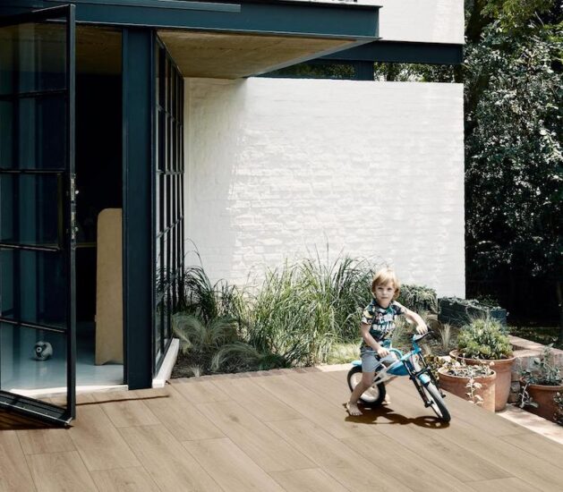 Kind auf dem Fahrrad auf kratz- und rutschfesten Außenplatten